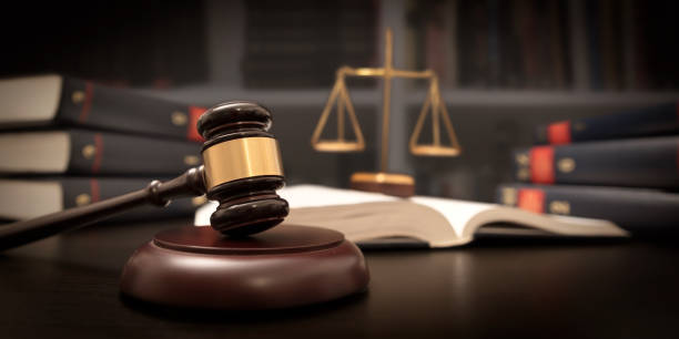 Judge gavel and scale in court. Library with lot of books in background Judge gavel and scale in court. Library with lot of books in background